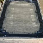 Modern Geometric Border Area Rug with a distressed or faded effect in shades of grey and blue